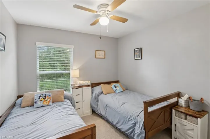 Bedroom featuring light colored carpet and ceiling fan