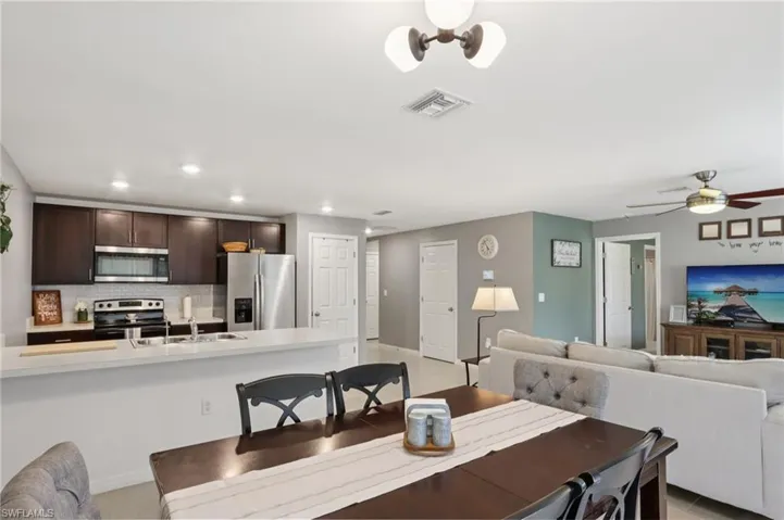 Dining area with recessed lighting and ceiling fan