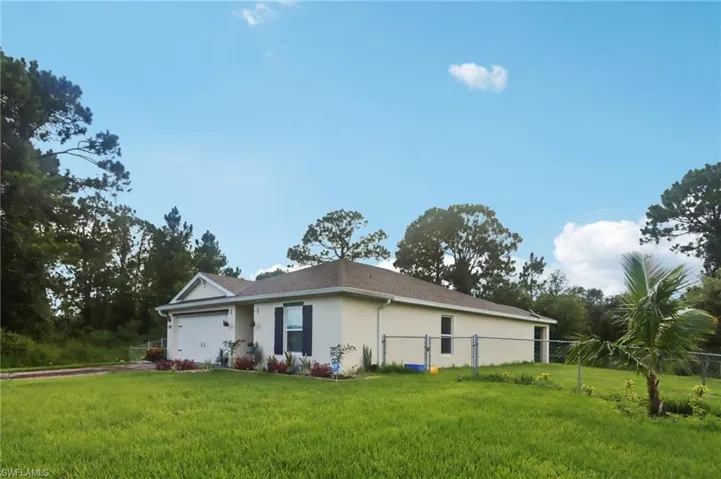 View of home's exterior with a garage and stucco siding
