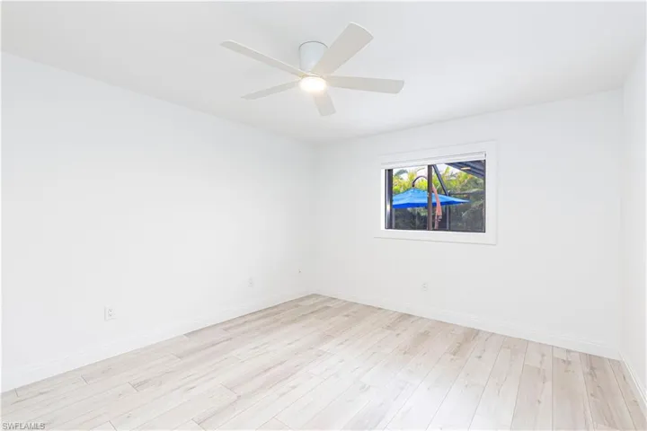 Empty room featuring ceiling fan and light wood-type flooring
