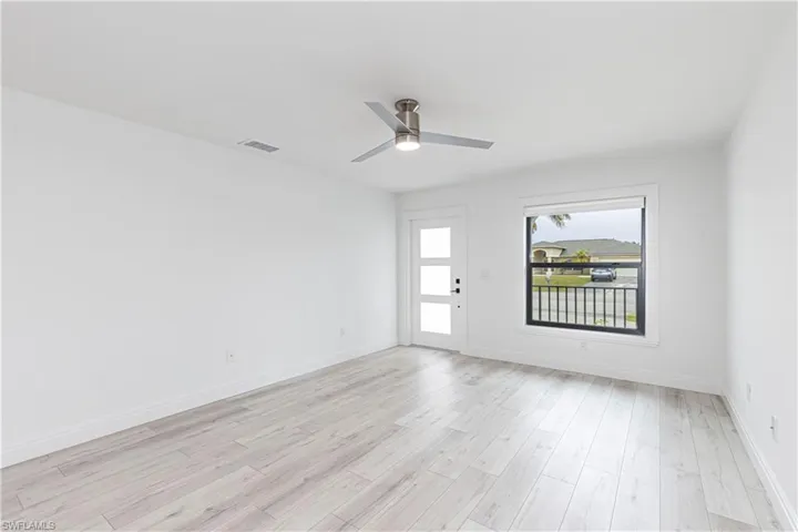 Unfurnished room with light wood-type flooring and ceiling fan