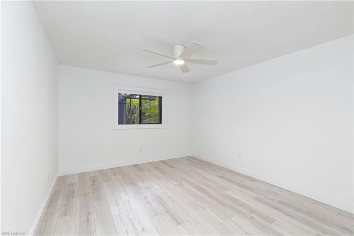 Spare room featuring ceiling fan and light hardwood / wood-style flooring