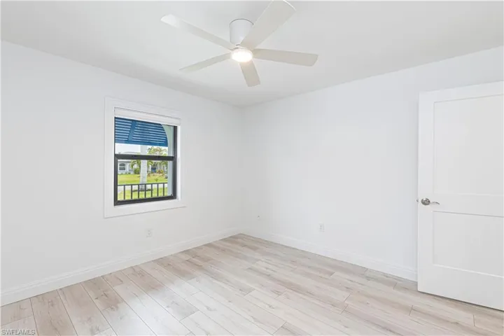 Unfurnished room with light wood-type flooring and ceiling fan