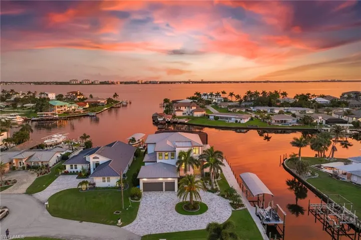Aerial view of residential area featuring a nearby body of water