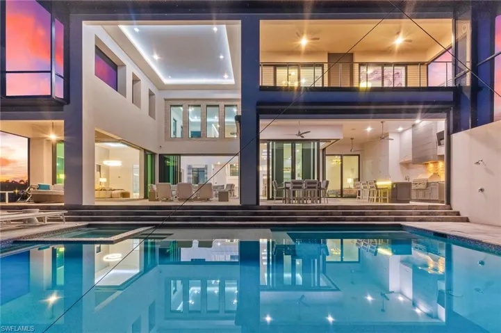 View of swimming pool with a patio area, a pool with connected hot tub, a ceiling fan, and outdoor dining area