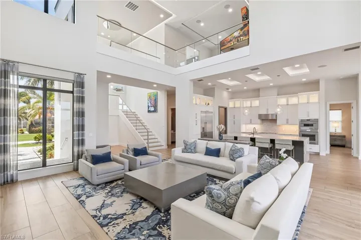 Living area featuring a towering ceiling and stairs