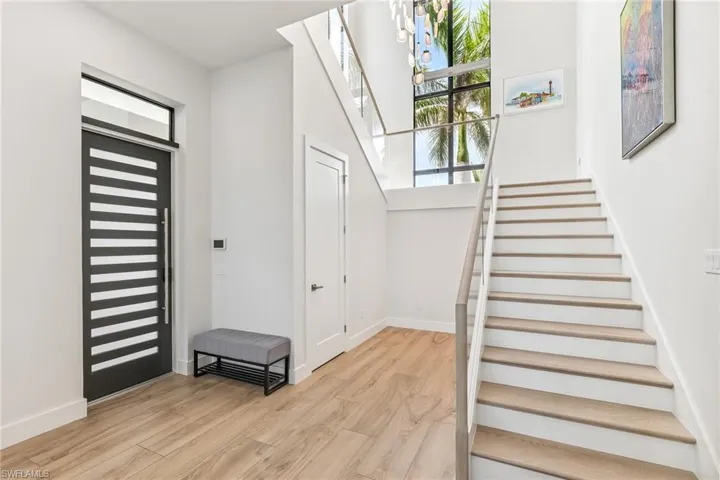 Foyer entrance featuring stairway and light wood-style flooring