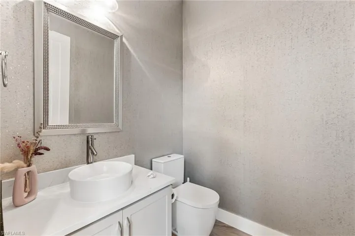 Full bathroom featuring a tile shower and vanity