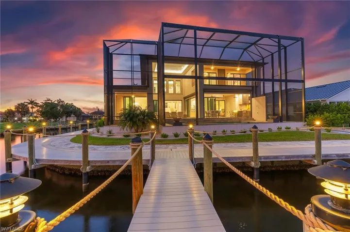 Exterior entry at dusk featuring stucco siding