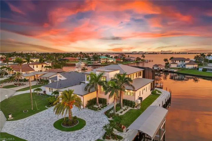 Rear view of property featuring a patio, a balcony, a lanai, and an outdoor pool