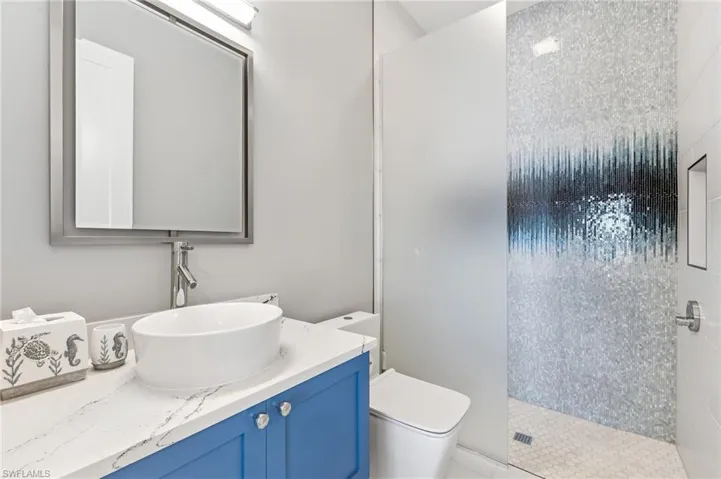 Bathroom with walk in shower and vanity