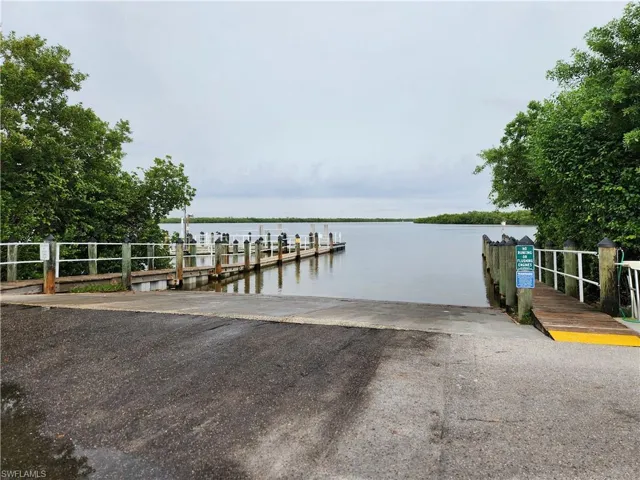 Dock area with a boat ramp and a water view