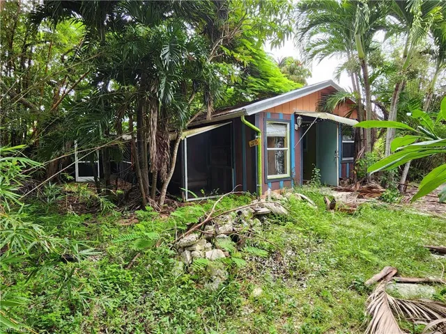 View of outdoor structure featuring a sunroom