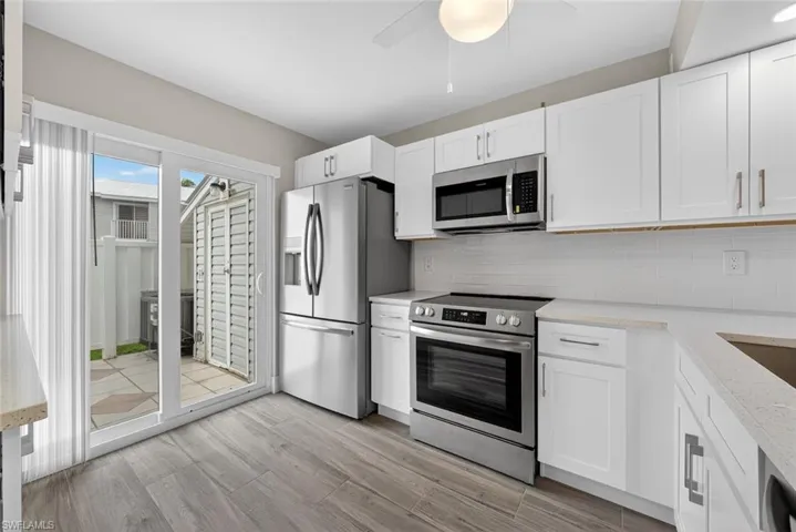 The kitchen has sliders to the fenced courtyard.