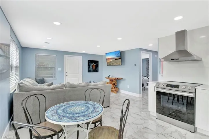 Dining area featuring light marble finish flooring and recessed lighting