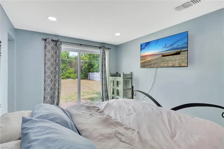 Bedroom featuring access to outside and recessed lighting