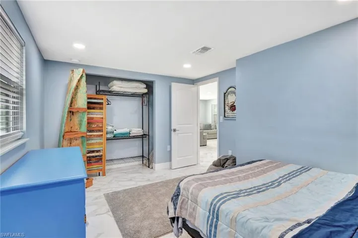 Bedroom featuring light marble finish floors and recessed lighting