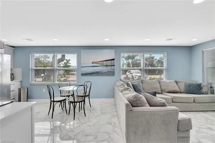 Living room featuring light marble finish flooring and recessed lighting