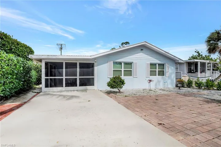 Back of house featuring a sunroom, a patio, and stucco siding