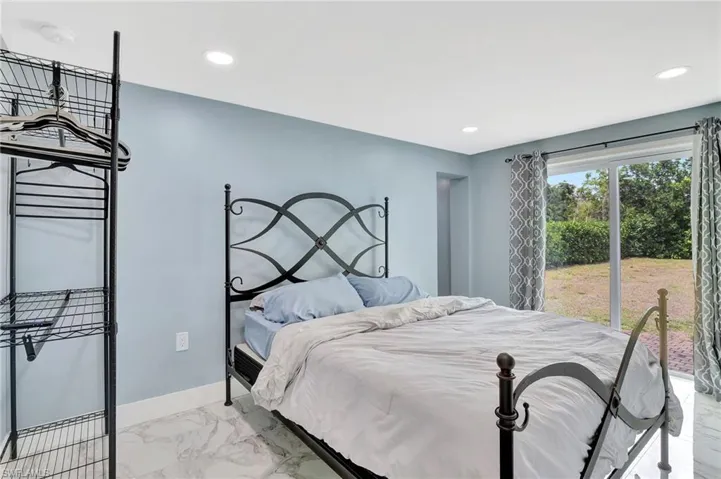 Bedroom with light marble finish flooring and recessed lighting