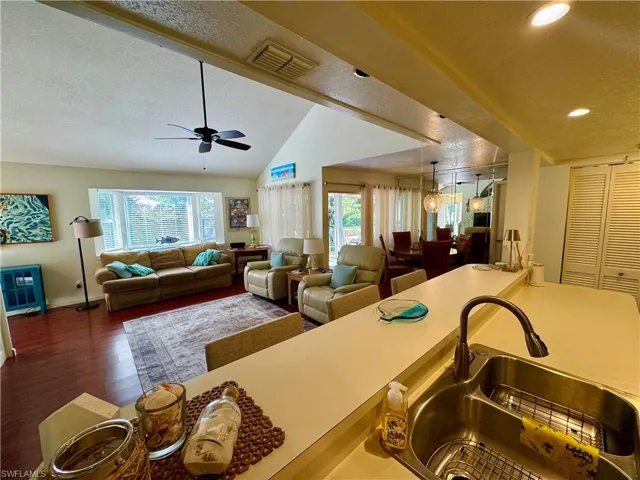 Kitchen with vaulted ceiling, a healthy amount of sunlight, visible vents, and a sink