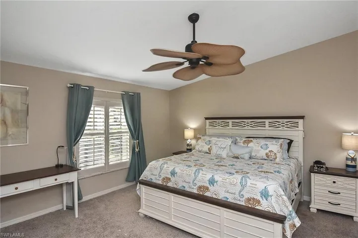 Carpeted bedroom with ceiling fan