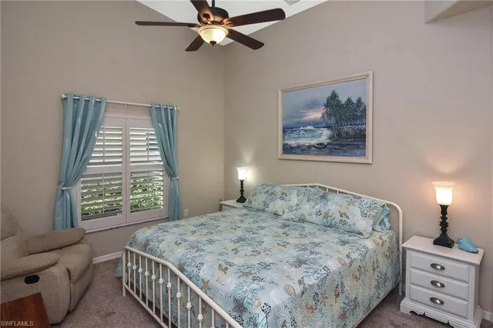 Carpeted bedroom with ceiling fan
