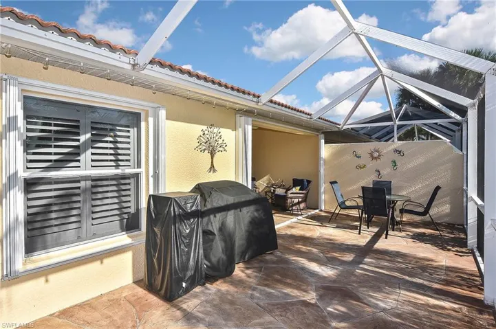 View of patio featuring screened enclosure