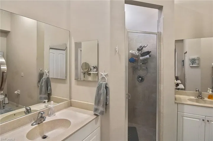 Bathroom featuring vanity and an enclosed shower