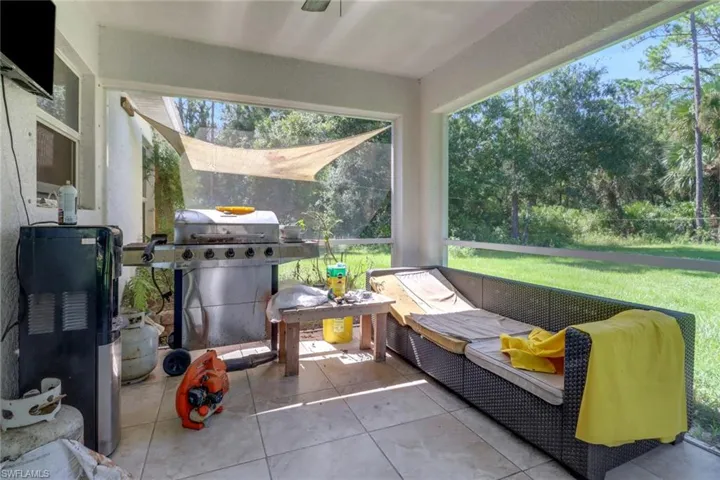 Covered Lanai with backyard and wooded view