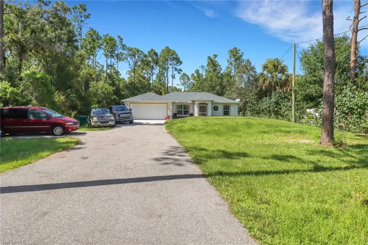 Single story home featuring a front lawn and a garage