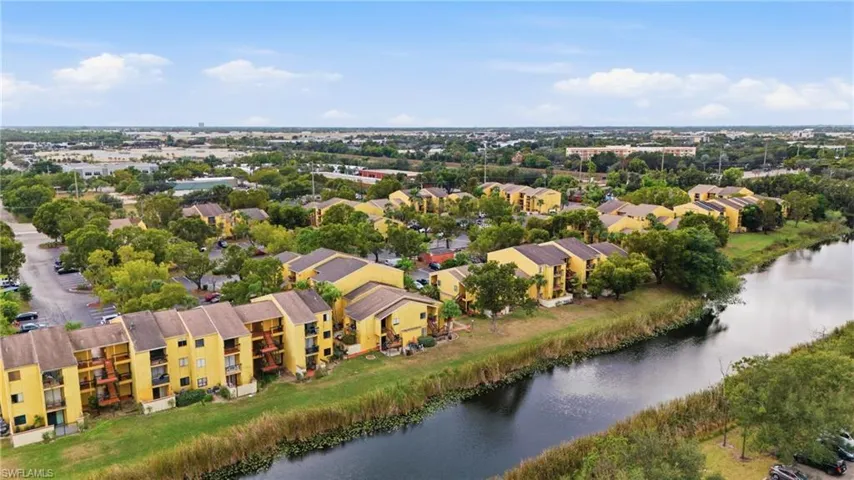 Waterfront residential buildings featuring private balconies and mature landscaping