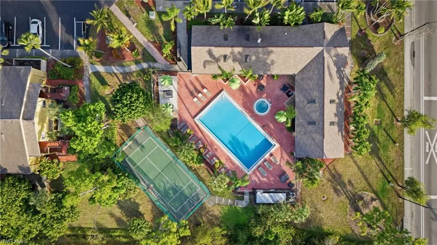 Community amenities featuring a swimming pool, hot tub, tennis court, and surrounding lounge areas