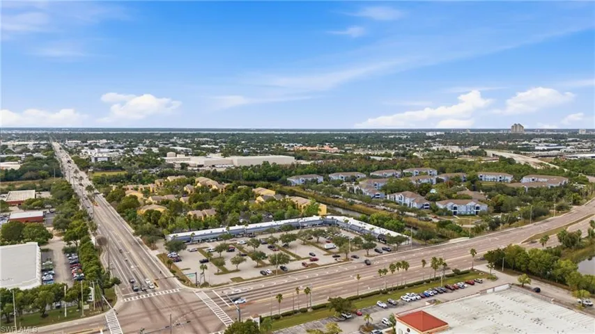 Aerial perspective showcasing a commercial strip center with ample parking