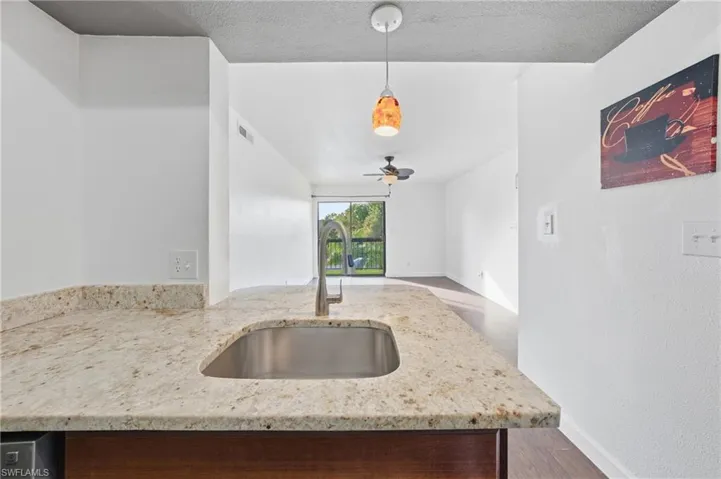 Kitchen island with a stainless steel undermount sink and a gooseneck faucet