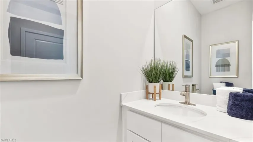 Modern bathroom vanity with a white countertop and an undermount sink