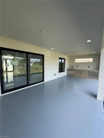 Unfurnished living room with plenty of natural light and concrete floors