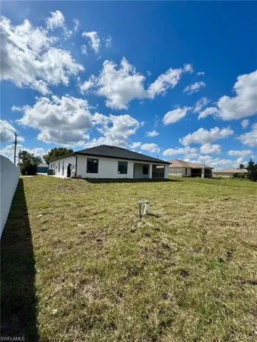 Rear view of house with a lawn