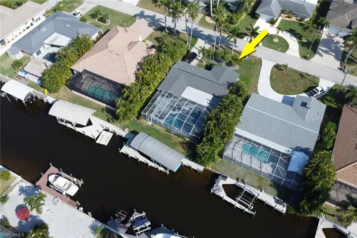 Aerial view of residential area featuring a large body of water