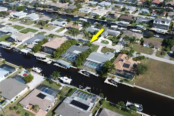 Aerial view of property's location featuring nearby suburban area and a nearby body of water
