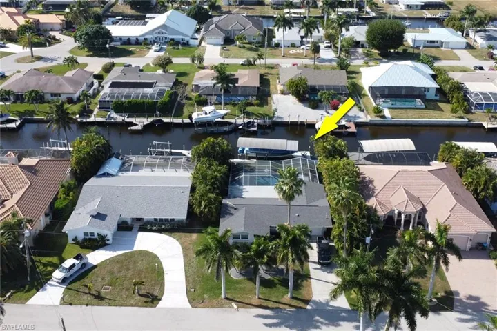 Aerial overview of property's location with nearby suburban area and a large body of water