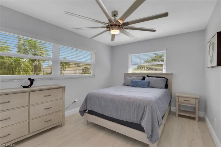 Bedroom with a ceiling fan and light wood-type flooring