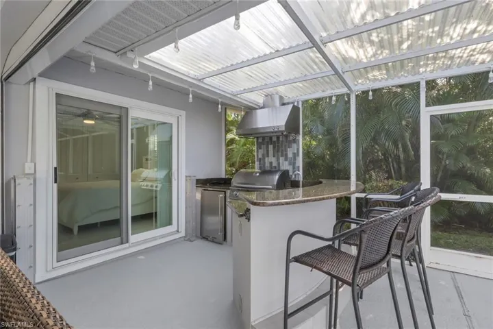 Sunroom / solarium featuring exterior kitchen