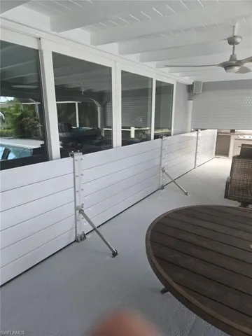 View of patio featuring area for grilling and a ceiling fan