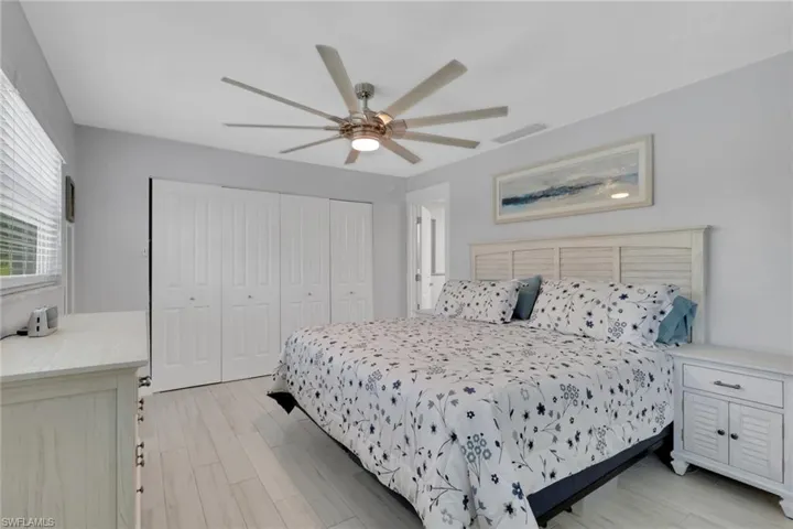 Bedroom featuring light wood-style flooring, a closet, and ceiling fan