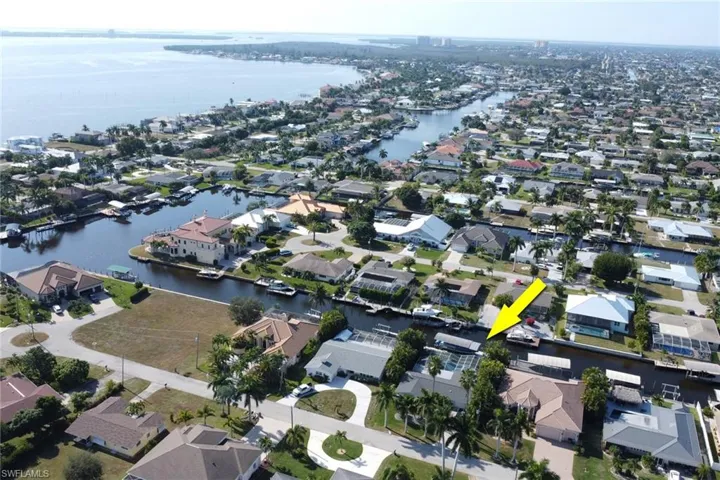Aerial view of property's location with nearby suburban area and a large body of water