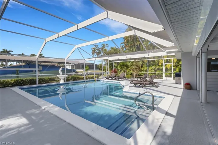 Outdoor pool featuring a lanai, a patio area, and a sunroom