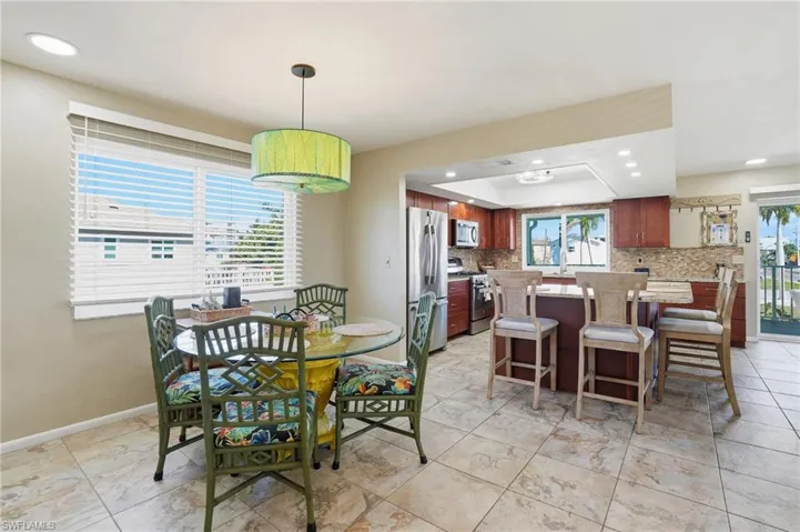Dining space with recessed lighting and baseboards - Virtually Edited Image