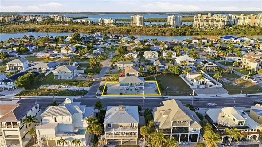 Aerial perspective of suburban area featuring a large body of water - Virtually Edited Image