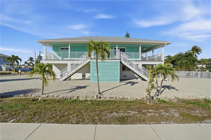 Raised beach house with stairs and a porch - Virtually Edited Image
